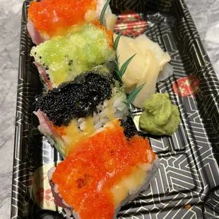 a plate of sushi with cavia and avocado