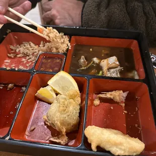 a person eating a meal with chopsticks