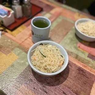 two bowls of noodles and a cup of green tea