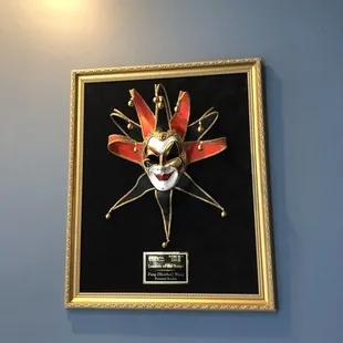 a mask mounted on a wall