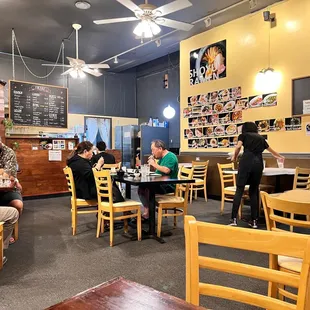 people sitting at tables in a restaurant