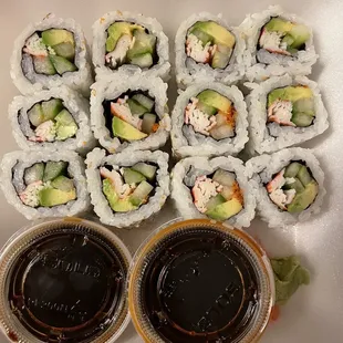 a variety of sushi rolls and dipping sauces