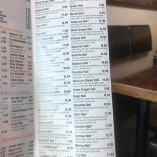 a hand holding a menu