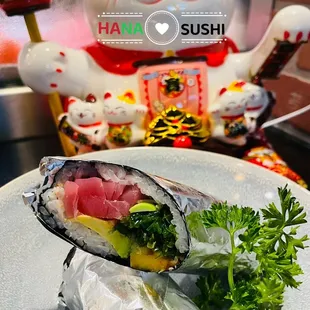 a plate of sushi and vegetables