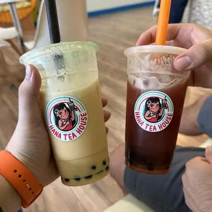 two people holding drinks