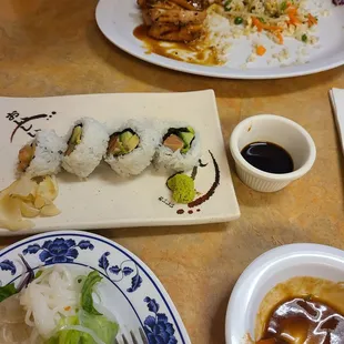 Salmon roll and chicken teriyaki with fried rice.