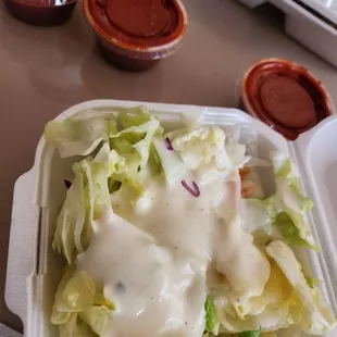 Salad and hot sauce.