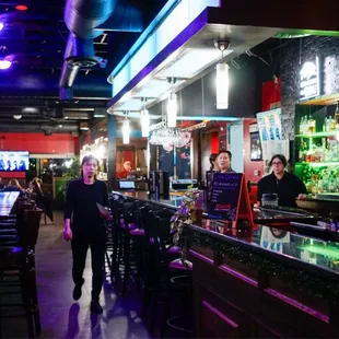 a woman standing at a bar