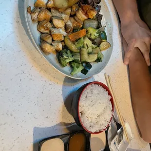 a plate of food with rice and vegetables