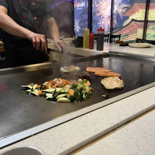 a man cooking on a grill