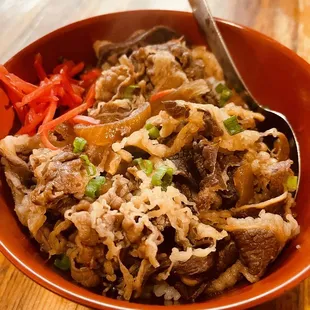 a close up of a bowl of ramen and vegetables