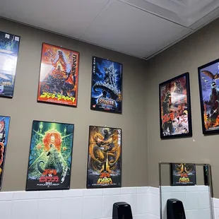 a bathroom with posters on the wall