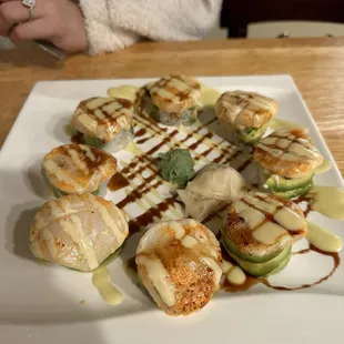 *Dragon Ferrari Roll - Baked Spicy Scallop topped w/spicy tuna, shrimp tempura, crab stick, avocado roll.