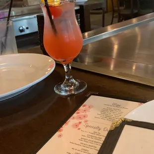 a drink and menu at a restaurant