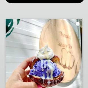 a hand holding a cupcake