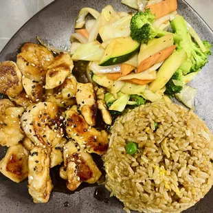 a plate of chicken, rice, and vegetables