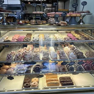 a variety of donuts in a display case
