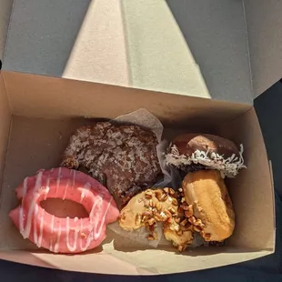 Raspberry old fashioned, maple pecan, chocolate with coconut, and an apple fritter.  Some were sampled before I took the picture.