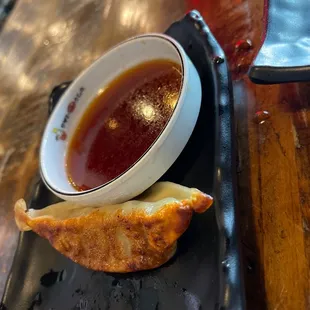 a bowl of soup and a piece of bread
