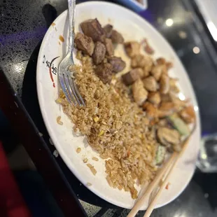 a plate of food with chopsticks