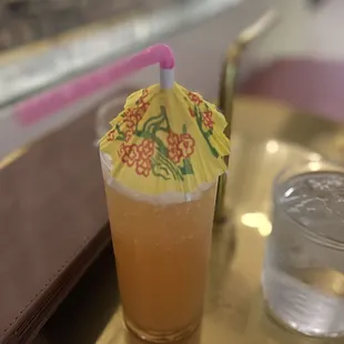 a drink in a glass with a paper umbrella