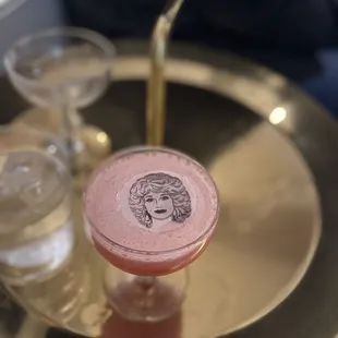 a pink drink with a woman's face on it