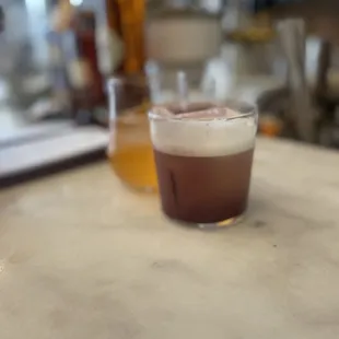 a drink in a glass on a table