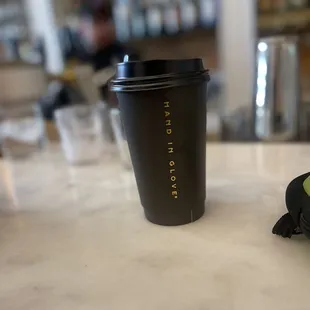 a cup of coffee and a sandwich