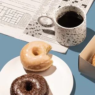 a cup of coffee and a box of doughnuts