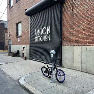 a bicycle parked in front of a union kitchen