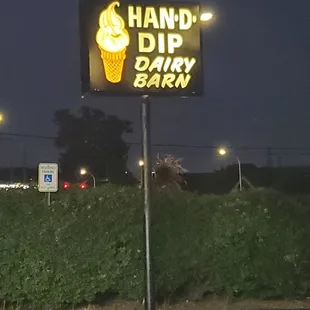 a neon sign for a dairy barn