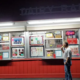 a man standing in front of a dairy barn