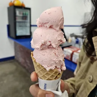 Strawberry ice cream with a waffle cone