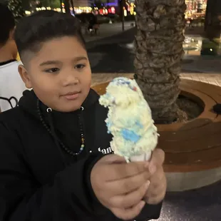 a young boy holding an ice cream cone