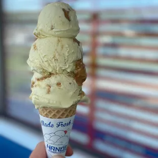  hand holding a cone of ice cream