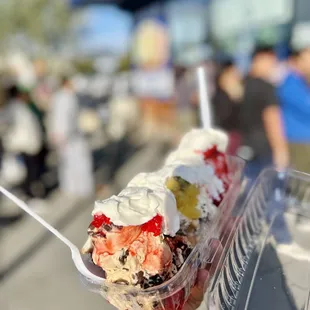 a hand holding a container of ice cream