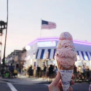 an ice cream cone in front of a store