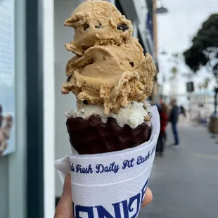 Dipped waffle cone with graham central station on too and Oreo beneath