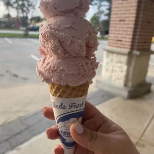 Strawberry ice cream in a sugar cone