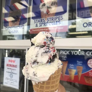 a hand holding an ice cream cone
