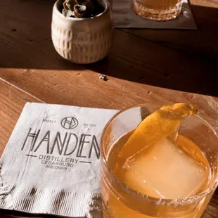 a glass of whiskey with a lemon wedge