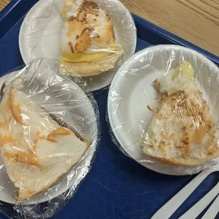 three plates of food wrapped in plastic