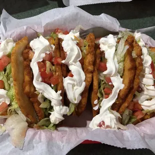 a basket of tacos and fries