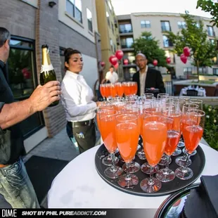 a man serving champagne to a group of people