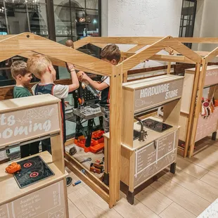 two children playing in a play house