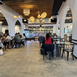 people sitting at tables in a restaurant