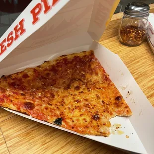a slice of pizza in a box