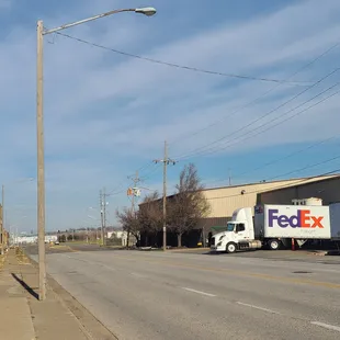 a fedex truck parked on the side of the road