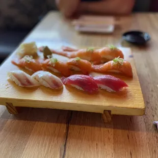 a plate of sushi and chopsticks