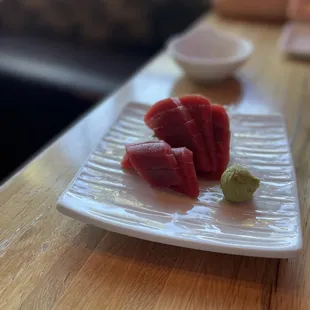 a plate of raw fish on a table